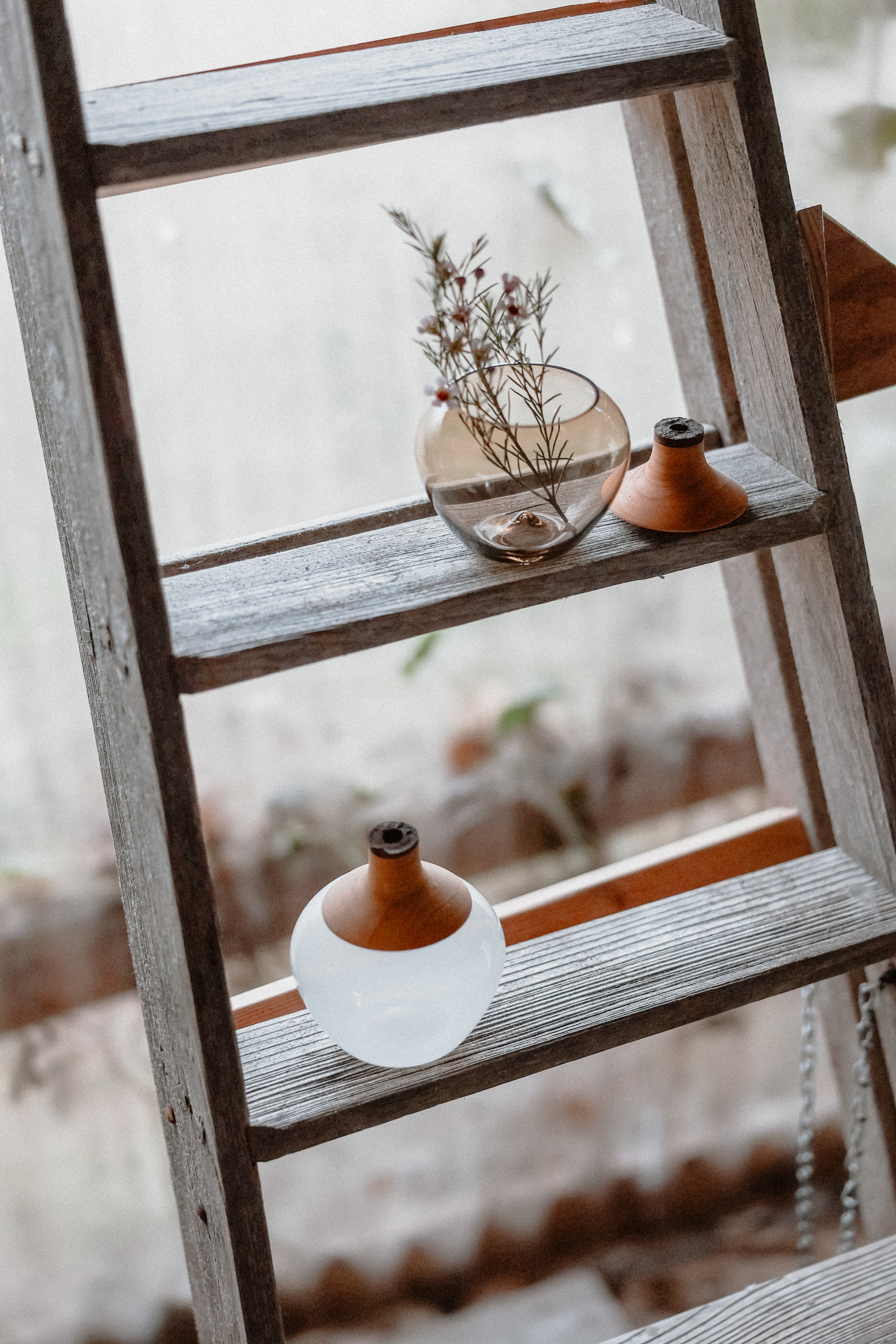Two Apple Stacking Vases displayed on a ladder, showcasing a modern and stylish design.