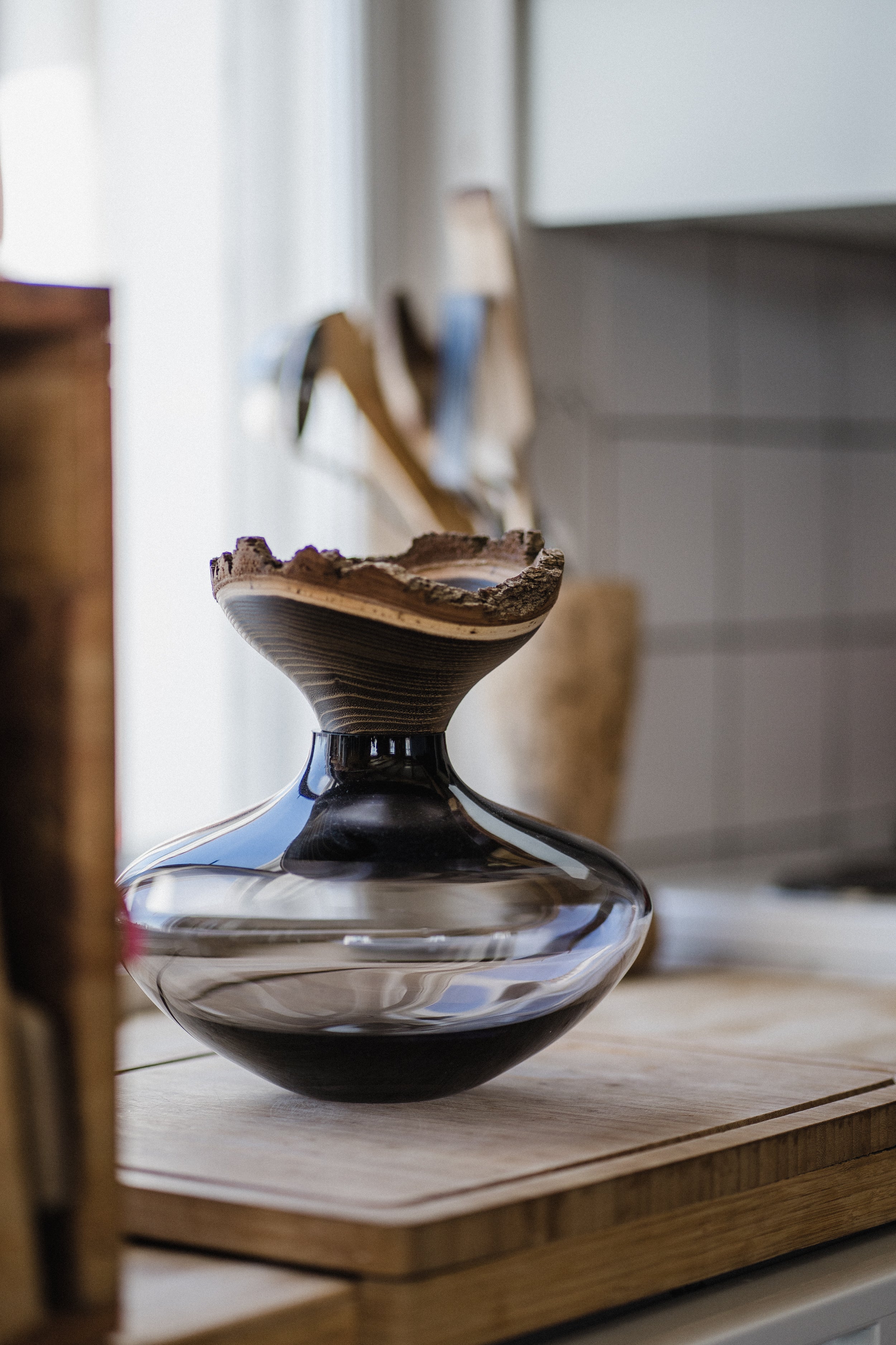 Bloom Stacking Vessel in Smoke in kitchen, showcasing a smooth, sophisticated design with a smoky finish and elegant stacking form.