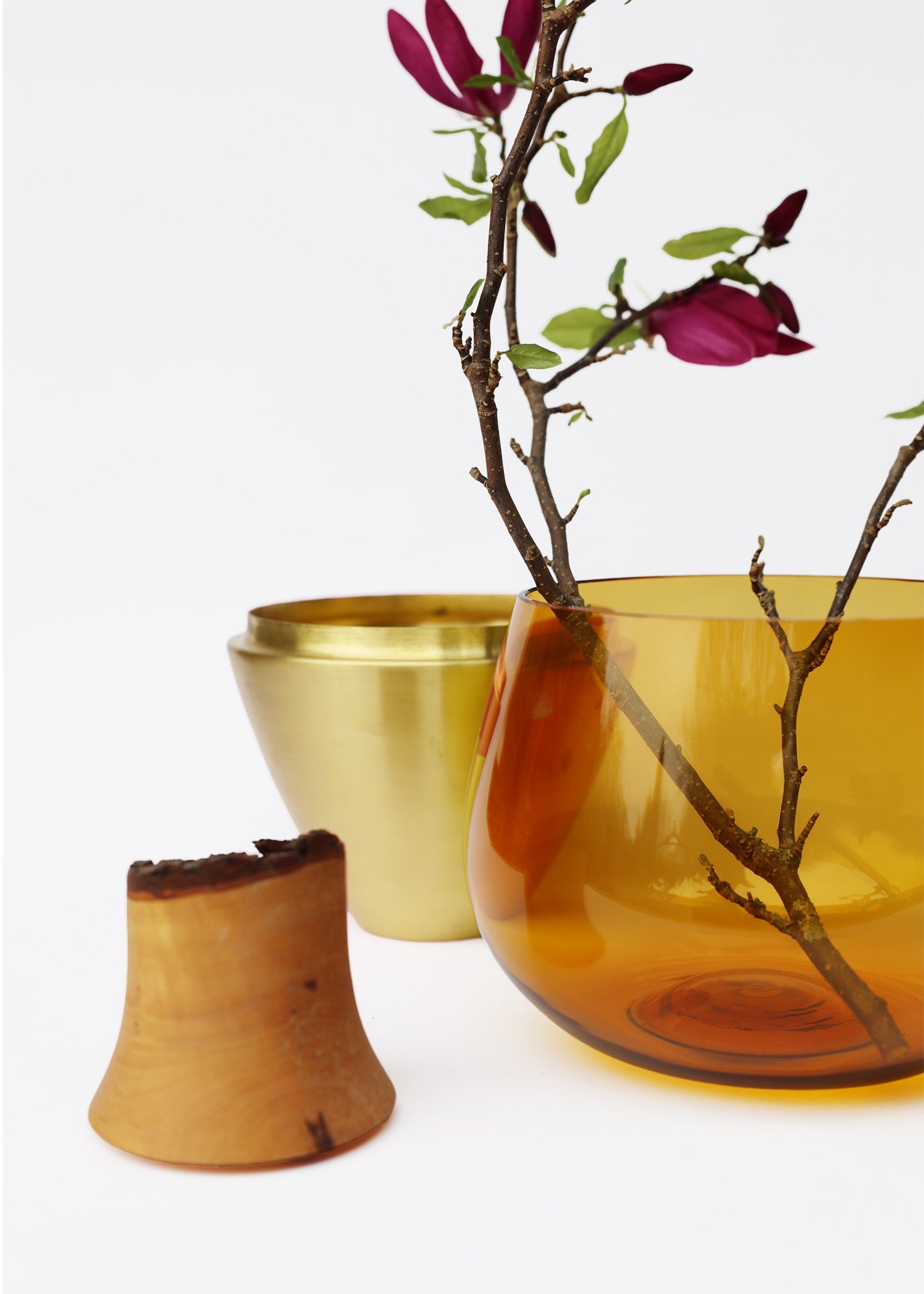 India I Stacking Vessel in Amber & Brass Unstacked with Flowers, merging the warm amber color with the elegance of brass for a timeless and refined design.