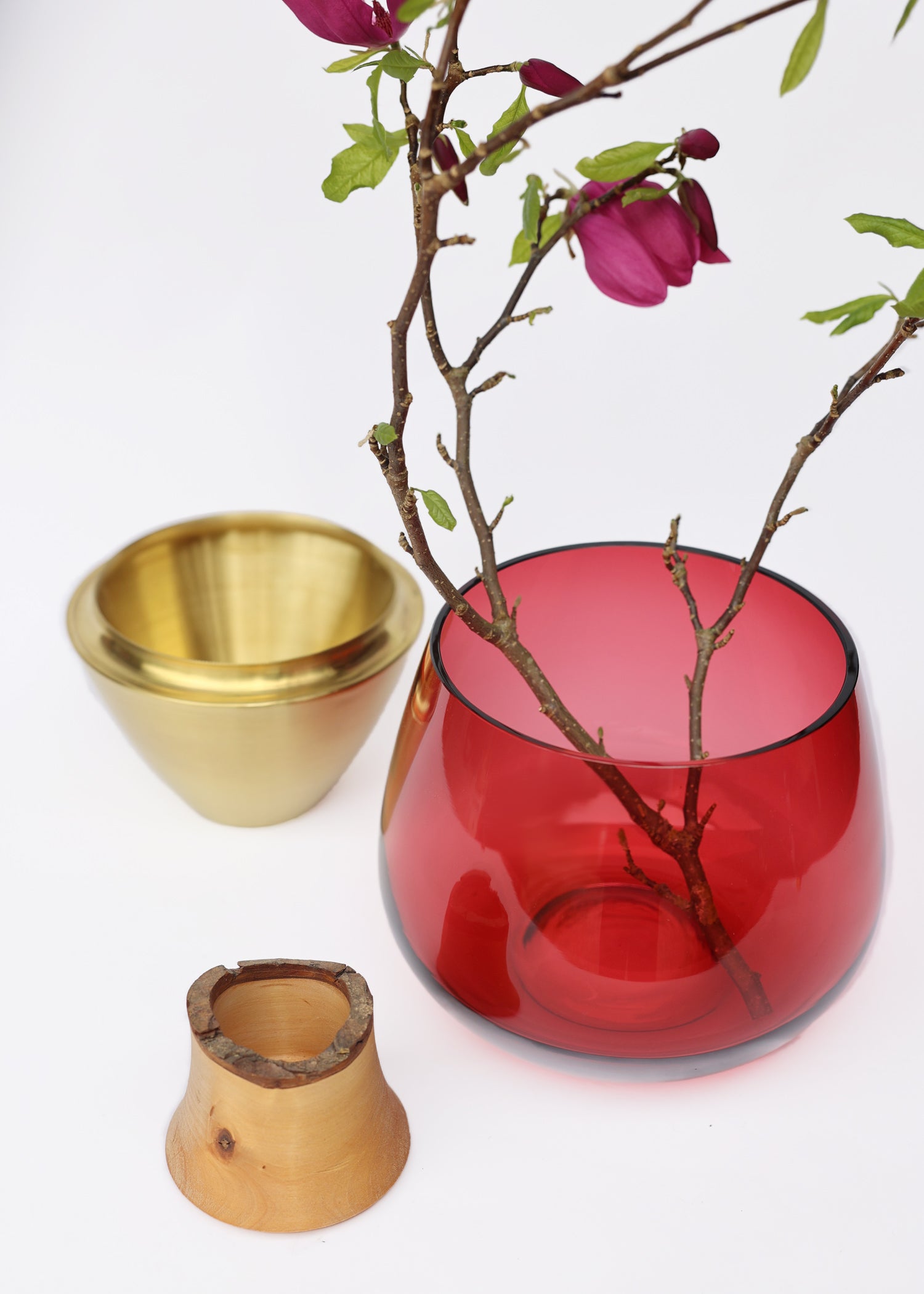 India I Stacking Vessel in Red & Brass Unstacked with Flowers, combining vibrant red hues with brass accents to create a bold and sophisticated statement piece.
