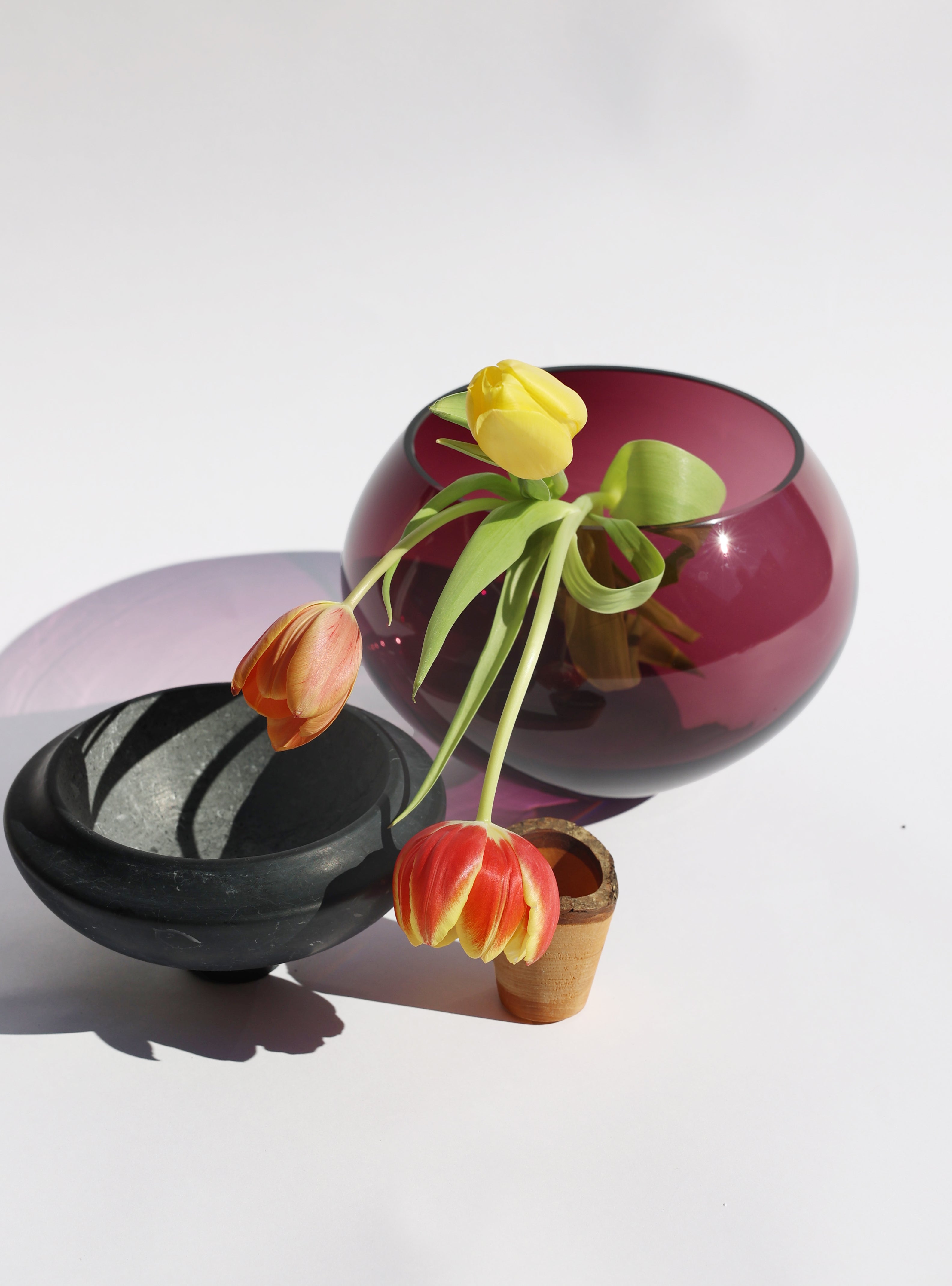 Istanbul Stacking Vessel in purple and black marble unstacked with flowers, offering a luxurious and striking design with sophisticated contrast.