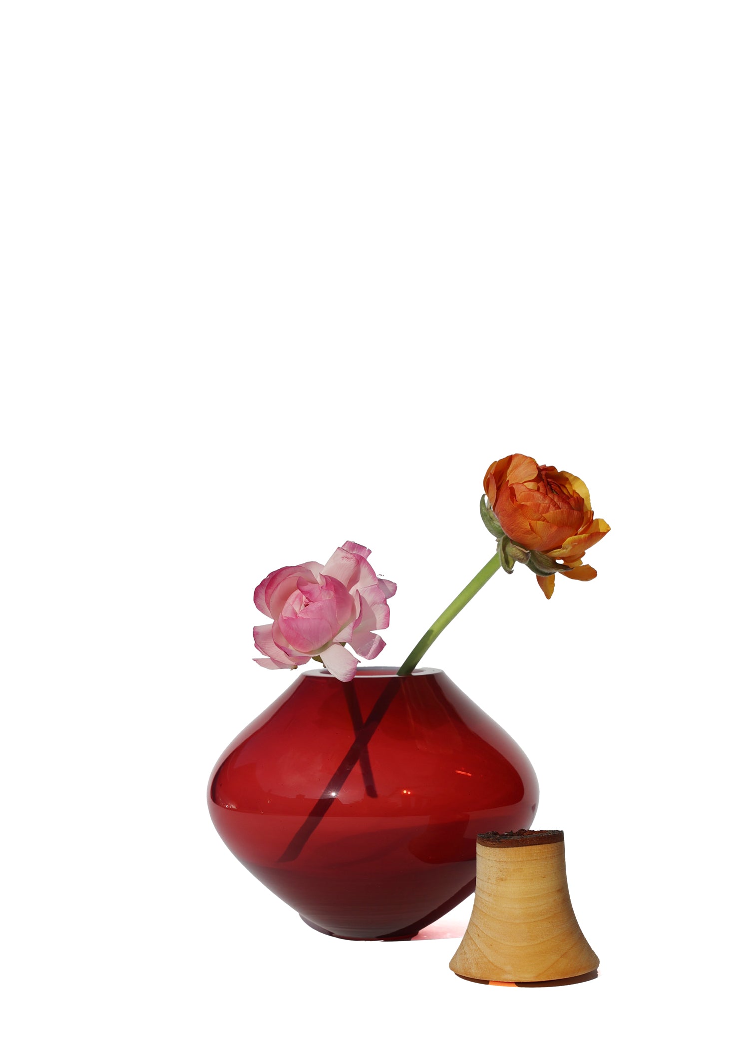 Matisse II Opalin Red Stacking Vessel unstacked with flowers, highlighting the intricate design and elegant details.