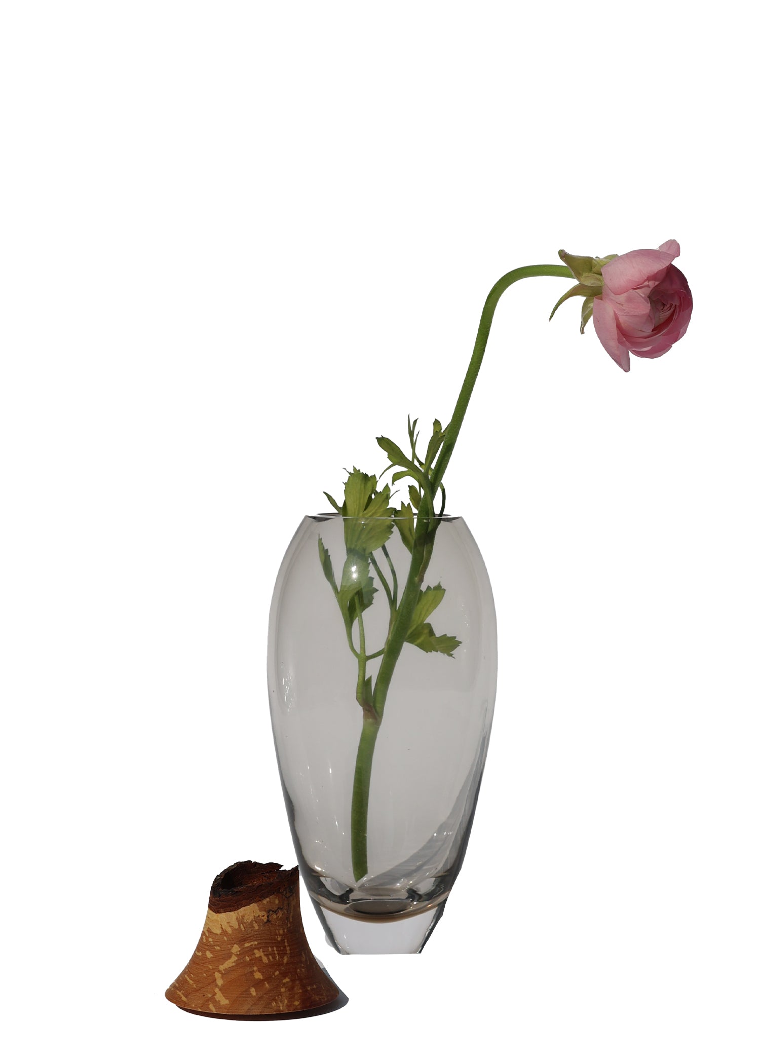 Matisse I Smoke Stacking Vessel unstacked with a flower, highlighting its minimalist design and elegant craftsmanship in a soft smoke color.