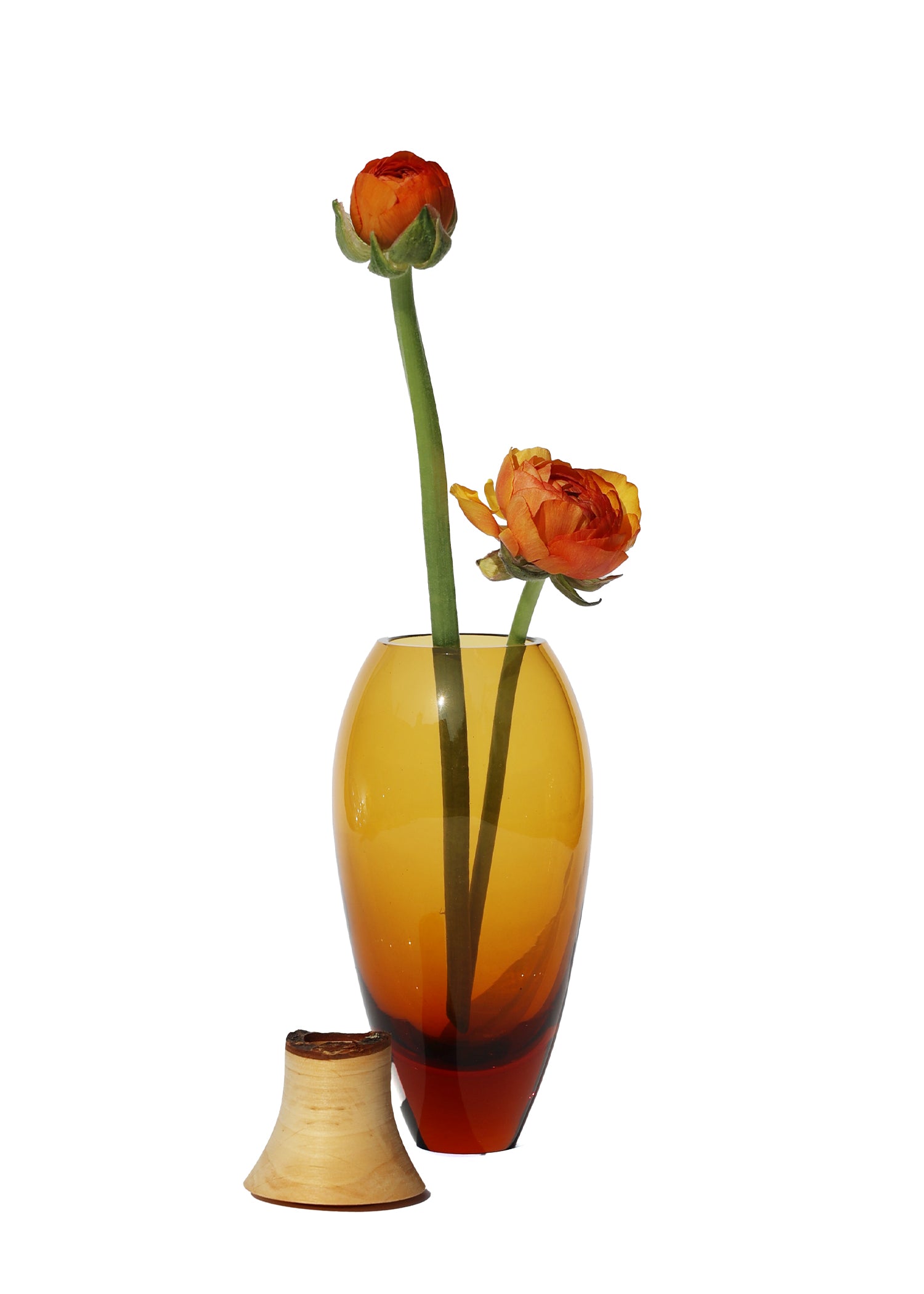 Matisse I Stacking Vessel in Dark Amber, unstacked and adorned with flowers, highlighting its elegant design.