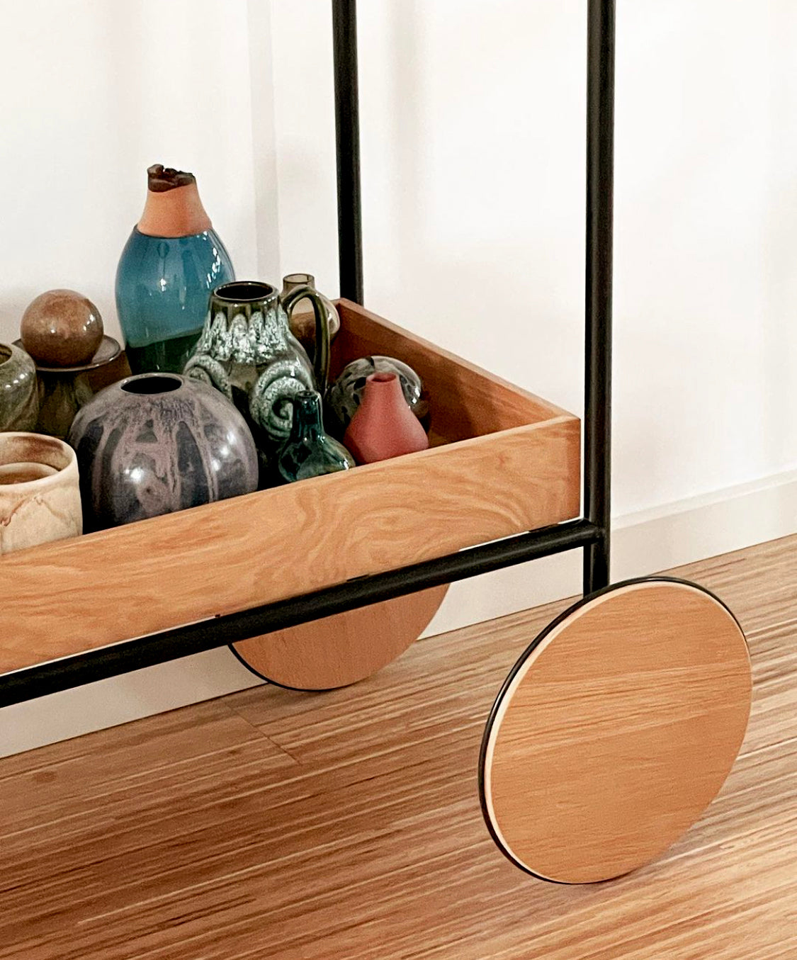 Matisse I Vase in Blue displayed on a trolley, emphasizing its sleek design and vibrant color.